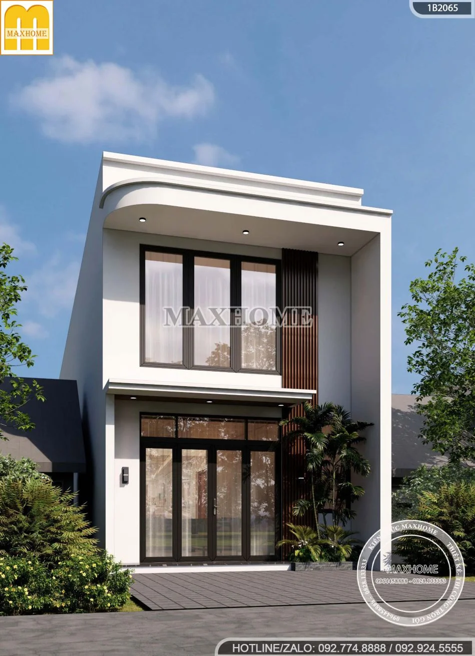 Mẫu nhà gác lửng đẹp hiện đại, thiết kế ngoại thất trắng đen, cửa kính lớn, sân vườn xanh mát.